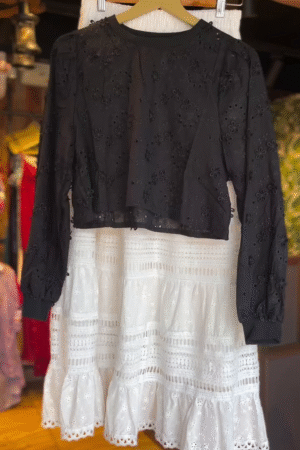 Black Floral Embroidered Sheer Long Sleeve Crop Top Paired with White High-Waisted Tiered Cotton Skirt Featuring Intricate Lace Cutwork and Eyelet Detailing – Perfect for Chic Daywear or Casual Outings