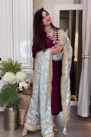 Maroon Embroidered Long Kurta with Heavily Embellished Sky Blue Net Dupatta Featuring Golden Floral Detailing and Traditional Jewelry Accents – Perfect for Festive and Wedding Occasions