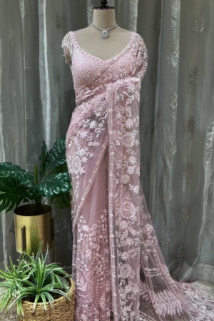 Graceful Baby Pink Net Saree with All Over Intricate White Thread and Sequin Embroidery, Paired with Heavy Embellished Matching Blouse Featuring Tassel Sleeves – Perfect for Weddings, Receptions, and Special Occasions