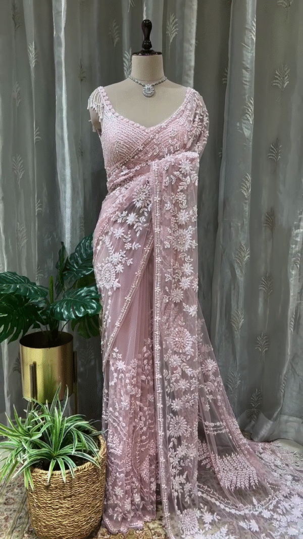 Graceful Baby Pink Net Saree with All Over Intricate White Thread and Sequin Embroidery, Paired with Heavy Embellished Matching Blouse Featuring Tassel Sleeves – Perfect for Weddings, Receptions, and Special Occasions
