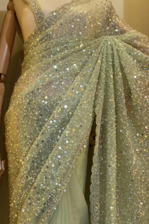 Stunning Pastel Green Soft Net Saree Adorned with All Over Heavy Sequin Work and Delicate Embroidered Lace Border, Perfect for Glamorous Party Looks, Evening Functions, and Reception Events
