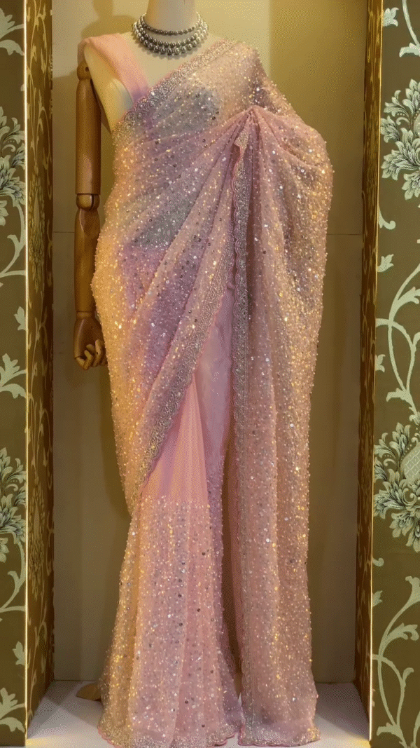 Glamorous Baby Pink Soft Net Saree Featuring All Over Heavy Sequin Embellishments with Delicate Lace Border Detailing, Ideal for Cocktail Parties, Sangeet Functions, and Evening Celebrations