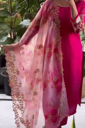 Rani Pink Embroidered Straight Suit Set Featuring Intricate Floral Handwork on Sheer Sleeves, Paired with a Soft Organza Floral Dupatta Accentuated by Golden Zari Embellishments and Delicate Beaded Borders – Perfect for Festive and Special Occasions