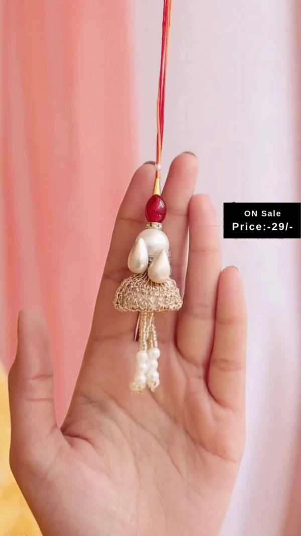 Golden Lumba Rakhi with Pearl Drops, Red Bead Accents, and Decorative Dome Design Paired with Matching Pearl Drop Oxidized Silver Toe Rings – A Graceful Raksha Bandhan Combo Set for Bhabhi Showcasing Traditional Charm and Festive Style