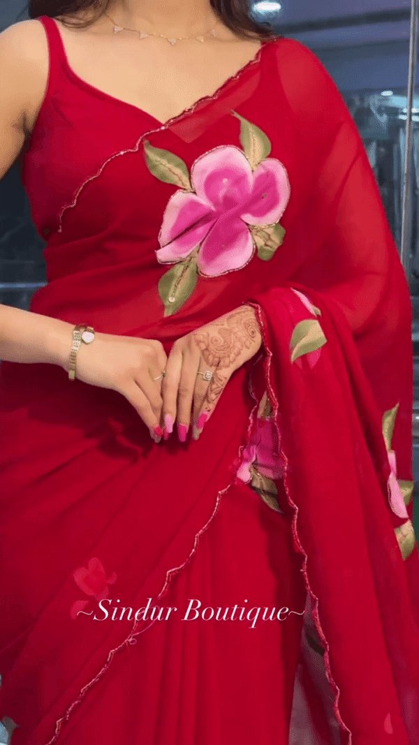 Red Georgette Saree with Hand-Painted Floral Design and Contrast Green-Pink Leaf Motifs, Paired with Matching Blouse and Delicate Border Detailing – Perfect for Festive and Traditional Wear - Image 2