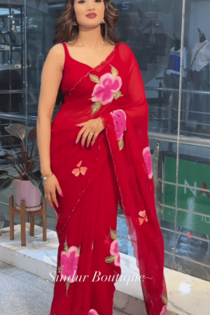 Red Georgette Saree with Hand-Painted Floral Design and Contrast Green-Pink Leaf Motifs, Paired with Matching Blouse and Delicate Border Detailing – Perfect for Festive and Traditional Wear