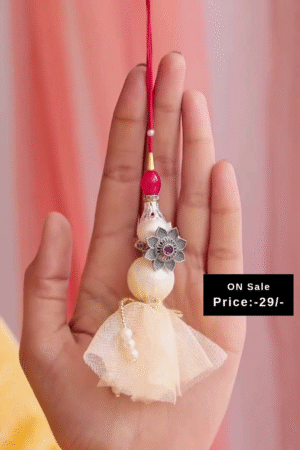 Handcrafted Cream Tassel Rakhi with Pearl Beads and Red Thread Detailing Paired with Elegant Silver-Toned Floral Adjustable Toe Rings Featuring Intricate Petal Design and Central Stone Accent – Ideal for Ethnic and Festive Wear