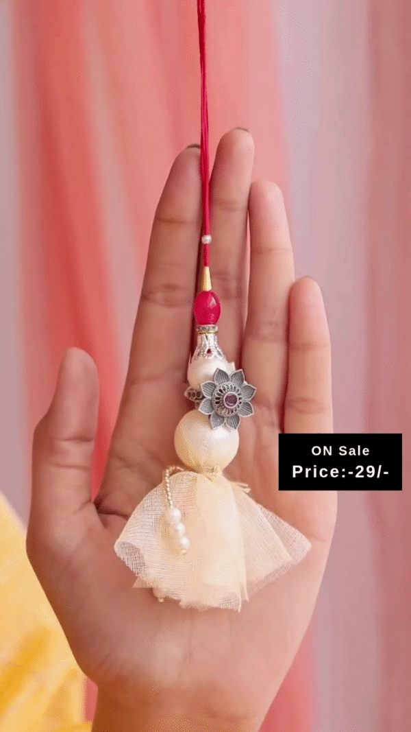 Handcrafted Cream Tassel Rakhi with Pearl Beads and Red Thread Detailing Paired with Elegant Silver-Toned Floral Adjustable Toe Rings Featuring Intricate Petal Design and Central Stone Accent – Ideal for Ethnic and Festive Wear